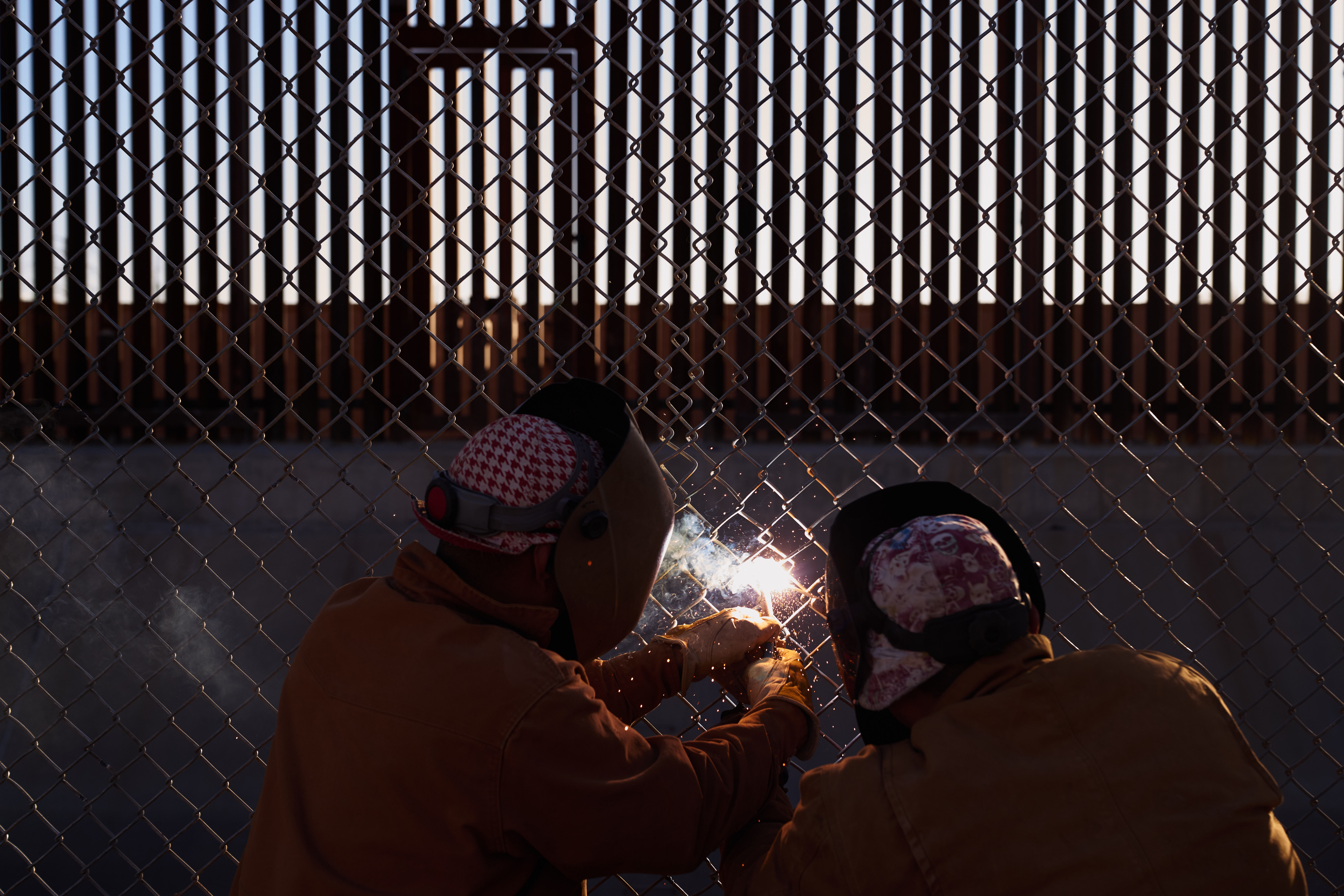 Welders weld gaps in the near the U.S.-Mexico Border Wall