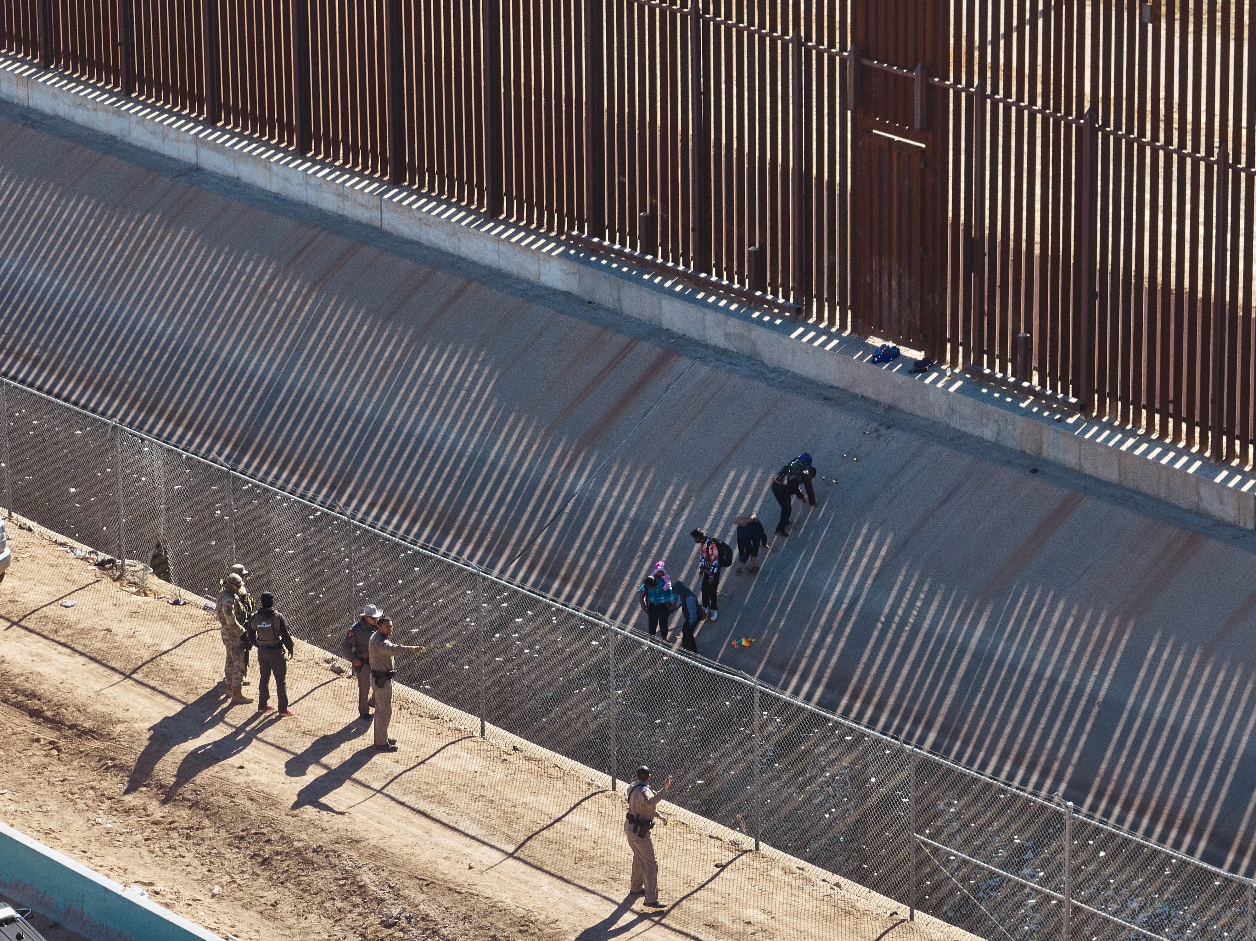 Migrants cross U.S.-Mexico Border Wall