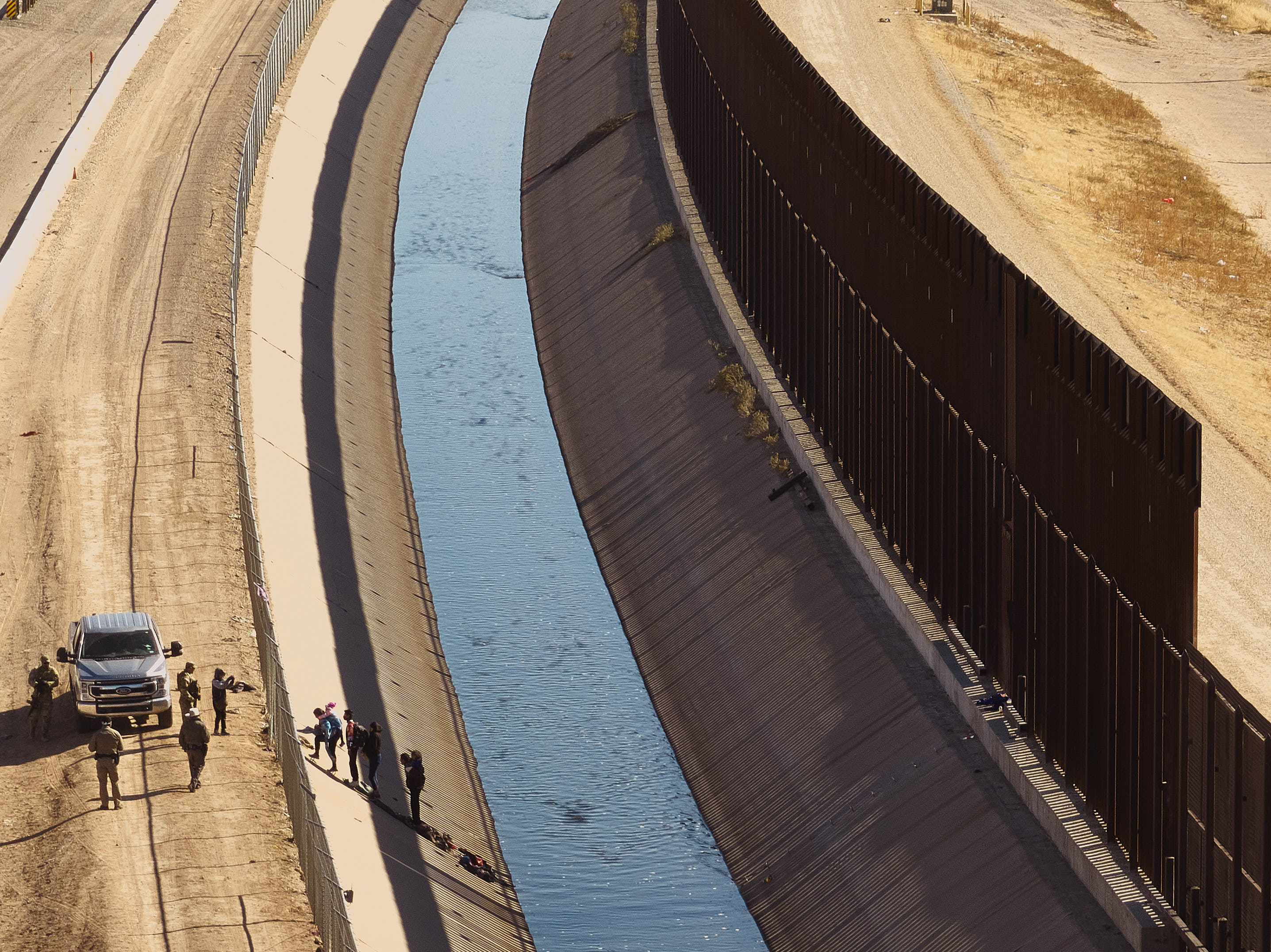 Migrants cross U.S.-Mexico Border Wall